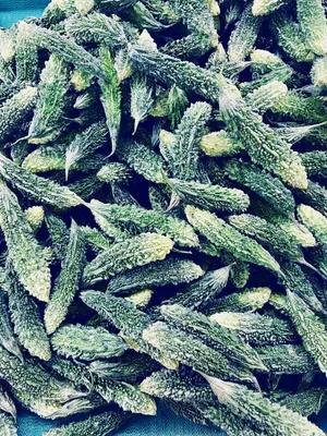 Pile of green, bumpy vegetables at the Asian grocery