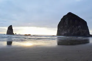 Rock formations on a beach at sunset