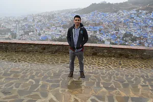 A man with the blue city in the background