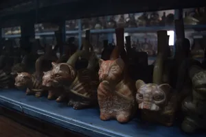 Incan ceramic cats on a shelf