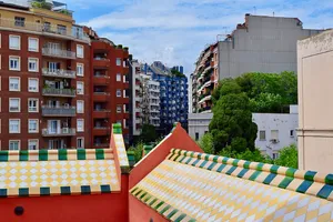 Checkered Gaudi roof and neighboring buildings