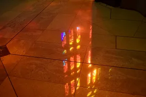 Stained glass light on tile floor