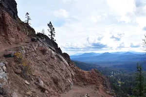 Dirt trail with distant hill layers