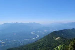 Hazy mountain valley with a winding creek