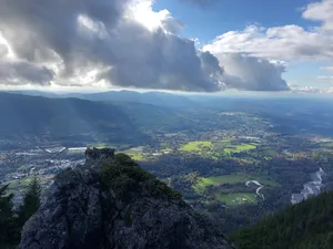 Valley with rays of sunlight peeking through clouds