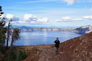 Woman donning sunglasses above Crater Lake